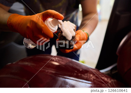 Cleaning a Luxury Car Seat with a Detail Brush and Foam for Maintaining Its Appearance Cleaning a Luxury Car Seat with a Detail Brush and Foam for Maintaining Its Appearance 126610641