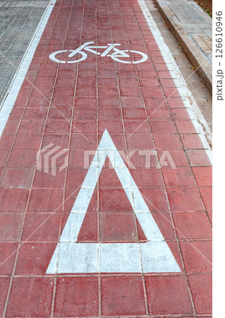 Spain, Valencia, March 29, 2024: Bicycle Lane Marking With a Red Pathway and Warning Symbol for Cyclists in an Urban Area Spain, Valencia, March 29, 2024: Bicycle Lane Marking With a Red Pathway and Warning Symbol for Cyclists in an Urban Area 126610946