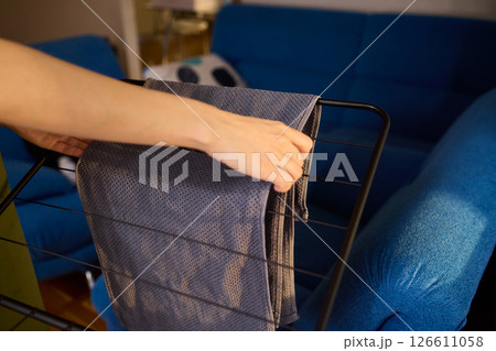 Arranging Freshly Laundered Towels Neatly on a Drying Rack for Optimal Drying and Organization 126611058