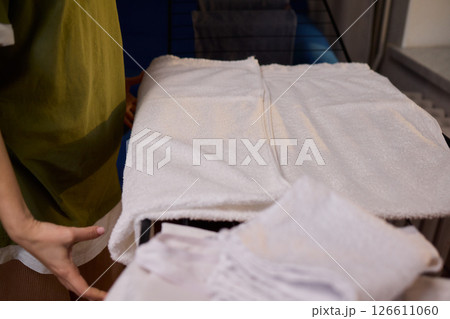 Arranging Freshly Laundered Towels Neatly on a Drying Rack for Optimal Drying and Organization Arranging Freshly Laundered Towels Neatly on a Drying Rack for Optimal Drying and Organization 126611060