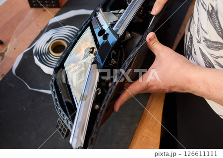 Careful precision is essential when installing a car headlight assembly for optimal performance 126611111