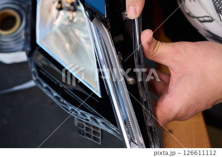 Careful precision is essential when installing a car headlight assembly for optimal performance Careful precision is essential when installing a car headlight assembly for optimal performance 126611112
