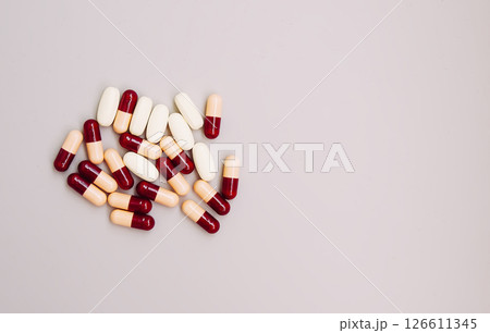 Pills scattered on light background. Medicine theme. Pills scattered on light background. Medicine theme. 126611345