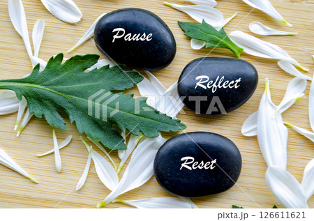 Top view of Zen stones with Pause, Reflect and Reset text. Representing inner peace of life Top view of Zen stones with Pause, Reflect and Reset text. Representing inner peace of life 126611621