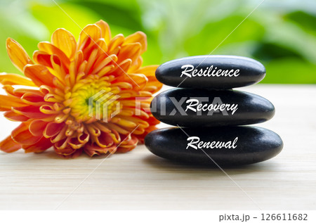 Close up view of Resilience, Recovery and Renewal text on Zen stones. Inner peace concept Close up view of Resilience, Recovery and Renewal text on Zen stones. Inner peace concept 126611682