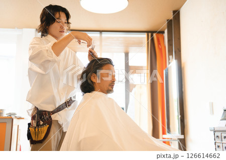 ヘアカットをする男性スタイリストと年配の男性客 126614662