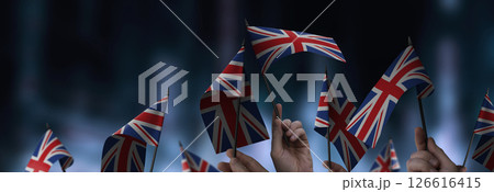 United Kingdom flags in their hands on a blurred urban background 126616415