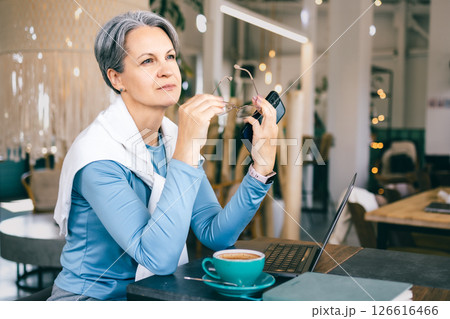 Senior woman with gray hair taking a mindful break from work, coping with fatigue 126616466