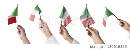 The Italy flag in hand in different angles on a white background The Italy flag in hand in different angles on a white background 126616826