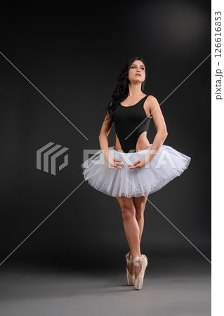 Ballet dancer showcasing elegance and strength in graceful pose 126616853