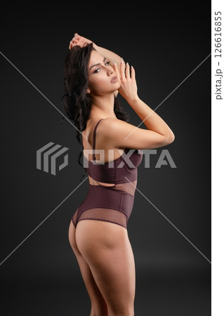 Graceful ballet dancer poses elegantly in a studio setting 126616855