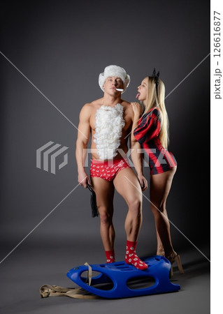 Couple engaging in playful roleplay at home with themed outfits and props Couple engaging in playful roleplay at home with themed outfits and props 126616877