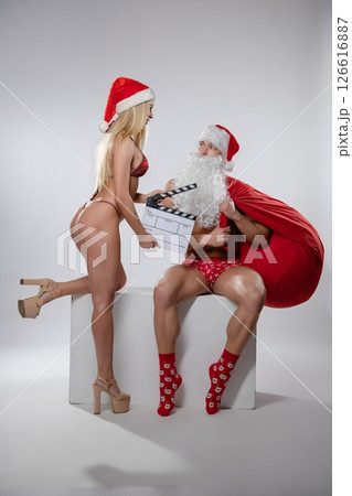 Couple engaged in playful roleplay with festive costumes and props 126616887