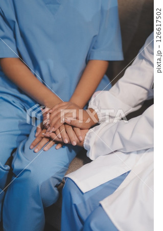 Close up images, The doctor holding hands patient to give advice and encourage To fight the disease And cheer to receive treatment, to elderly patient and health care concept. 126617502