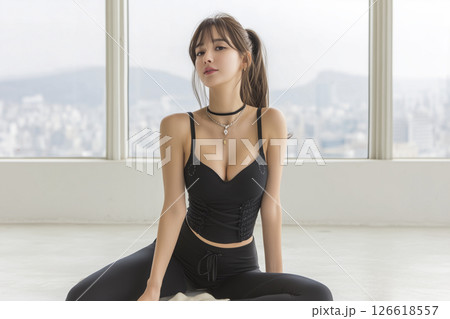 Woman is sitting on the floor wearing black clothes 126618557