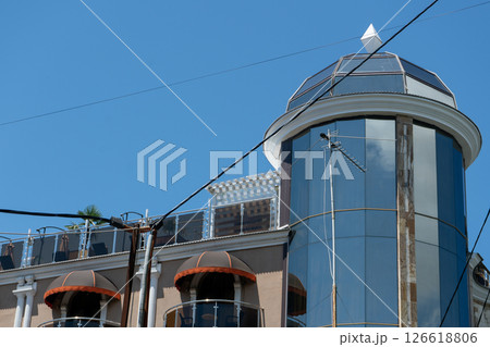 Facade of a multi story building with mirrored windows and balconies. Facade of a multi story building with mirrored windows and balconies. 126618806