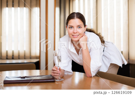 Portrait of sexy businesswoman with glass of wine at table Portrait of sexy businesswoman with glass of wine at table 126619109
