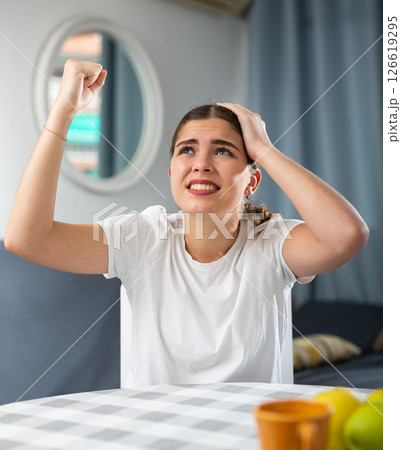 Stressed young woman suffering from noisy neighbors 126619295