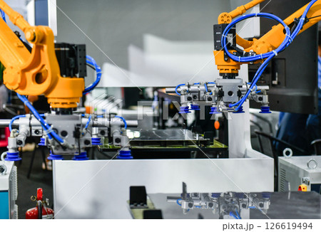 Robot arm control the Steel sheet cutting process in the industrial factory Robot arm control the Steel sheet cutting process in the industrial factory 126619494