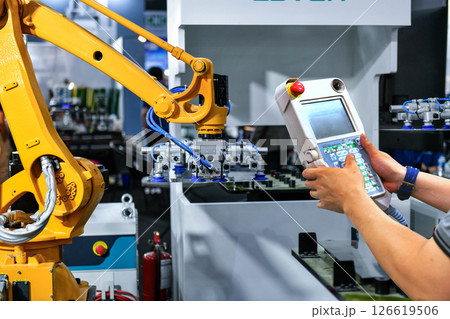 A worker is pressing a steel plan control button to enter the steel cutting process in the industrial factory A worker is pressing a steel plan control button to enter the steel cutting process in the industrial factory 126619506