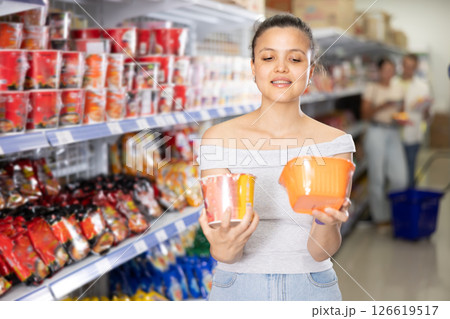 Asian female shopper choosing instant ramen in supermarket 126619517