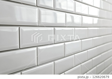 Ceramic tiles with a glossy finish and beveled edges set into horizontal brickwork. The sleek and clean wall design is ideal for kitchens and bathrooms with a minimalist or modern aesthetic. Banner 126620679