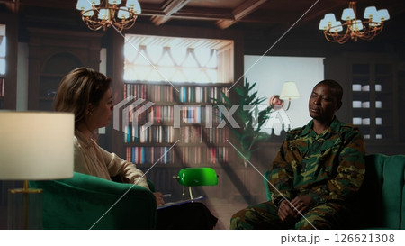 Armed forces officer discussing about his war memories during counseling session, joining a rehabilitation program for soldiers. Trooper opening up about PTSD and trauma. Camera B. Armed forces officer discussing about his war memories during counseling session, joining a rehabilitation program for soldiers. Trooper opening up about PTSD and trauma. Camera B. 126621308