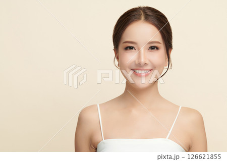 A beautiful young Asian woman with clean, fresh skin against a beige background. Skincare, facial treatment, cosmetology, beauty, and spa. An elegant portrait of an Asian woman. A beautiful young Asian woman with clean, fresh skin against a beige background. Skincare, facial treatment, cosmetology, beauty, and spa. An elegant portrait of an Asian woman. 126621855
