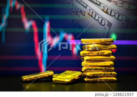 Photo a gold bars the candlestick chart and US dollar background , Fluctuations in gold prices concept. 126621937