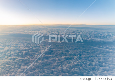 Beautiful orange and pink sunrise over the clouds, view from the plane. 126623193