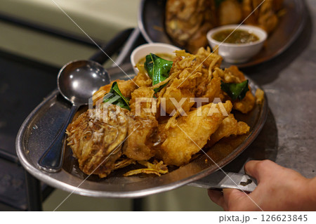 Deep fried red tilapia with papaya salad, Thai traditional food Deep fried red tilapia with papaya salad, Thai traditional food 126623845