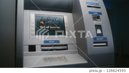 Unrecognizable Vandal in Hoodie Marking ATM Screen with Graffiti Using Marker Pen 126624593
