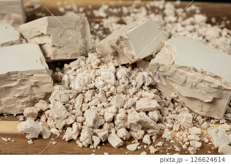 Compressed fresh yeast cubes close-up on a wooden background. Compressed fresh yeast cubes close-up on a wooden background. 126624614