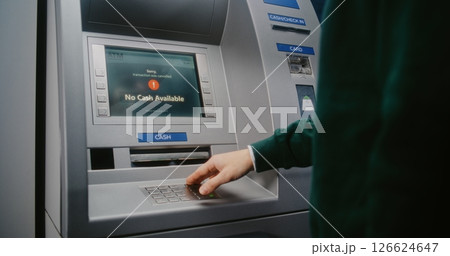 Unrecognizable Person Entering PIN Code. Error Message on Cash Machine Display Due to No Cash Available 126624647