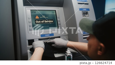 Professional Cleaner Wiping Out ATM with Microfiber Rag, Cleaning Away Dirt and Dust 126624714