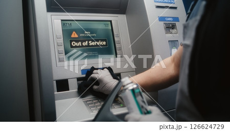 Cleaner Wiping Vandalized ATM Machine with Rag, Removing Graffiti Cleaner Wiping Vandalized ATM Machine with Rag, Removing Graffiti 126624729