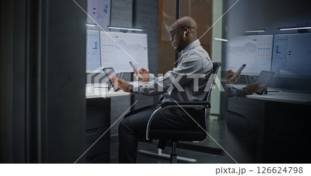 Stock Trader Monitoring Real-Time Stocks on Digital Devices and Computer with Multi-Monitor Desktop Stock Trader Monitoring Real-Time Stocks on Digital Devices and Computer with Multi-Monitor Desktop 126624798