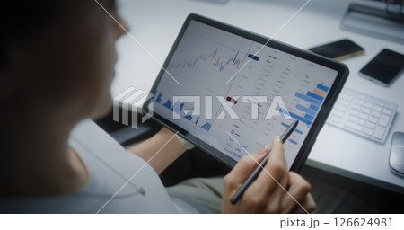 Female Stock Exchange Broker Analyzing Real-Time Stocks Using Digital Tablet and Stylus 126624981