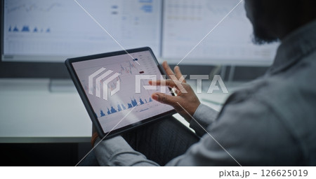 Stock Exchange Trader Monitoring Real-Time Stocks and Exchange Market Charts on Digital Tablet Stock Exchange Trader Monitoring Real-Time Stocks and Exchange Market Charts on Digital Tablet 126625019