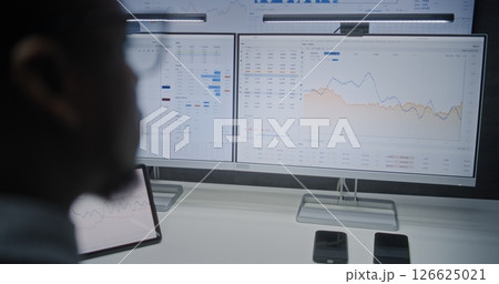 Multi-Monitor Computer with Online Trading Software. Stock Exchange Trader Analyzing Real-Time Stocks Multi-Monitor Computer with Online Trading Software. Stock Exchange Trader Analyzing Real-Time Stocks 126625021