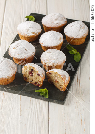 Stollen Small fruitcakes for Christmas dinner closeup on the board . Vertical 126625875