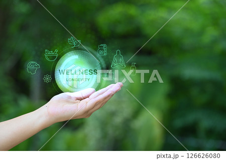 Open hand holding virtual icons representing longevity, health, and holistic wellbeing 126626080