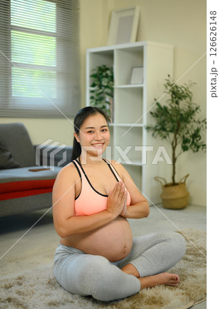 Expecting mother practicing meditation for mental calm and physical wellness 126626148