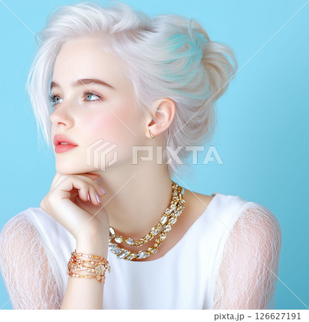 A stunning young woman with vibrant white and teal hair, striking blue eyes,chic jewelry looks thoughtfully to the side.blue background is perfect for fashion,beauty, hair care,lifestyle content. 126627191