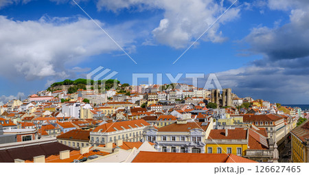 Scenic panoramic view of Lisbon historic Alfama district, St George castle on hill top with lush foliage, Gothic cathedral Se and colorful houses with terracotta rooftops on sunny day, clear blue sky Scenic panoramic view of Lisbon historic Alfama district, St George castle on hill top with lush foliage, Gothic cathedral Se and colorful houses with terracotta rooftops on sunny day, clear blue sky 126627465