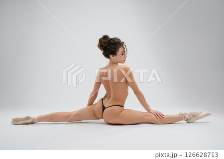 Graceful ballet dancer showcasing flexibility in elegant nude pose 126628713