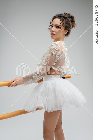 Elegant ballet dancer in soft light showcasing grace and strength Elegant ballet dancer in soft light showcasing grace and strength 126628745