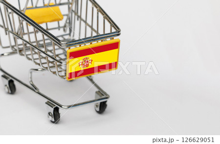 Shopping, VAT and retail in Spain concept. Shopping Cart with Spanish flag on white background Shopping, VAT and retail in Spain concept. Shopping Cart with Spanish flag on white background 126629051