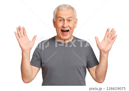 PNG happy elderly man in grey t shirt with raised hands and surprised expression isolated on transparent background. Concept of excitement, positive emotions, joyful senior portrait for design 126629075