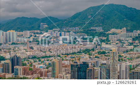 Buildings Surrounded by Lush Greenery and Mountains Buildings Surrounded by Lush Greenery and Mountains 126629261